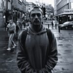 man wearing grey hooded jacket